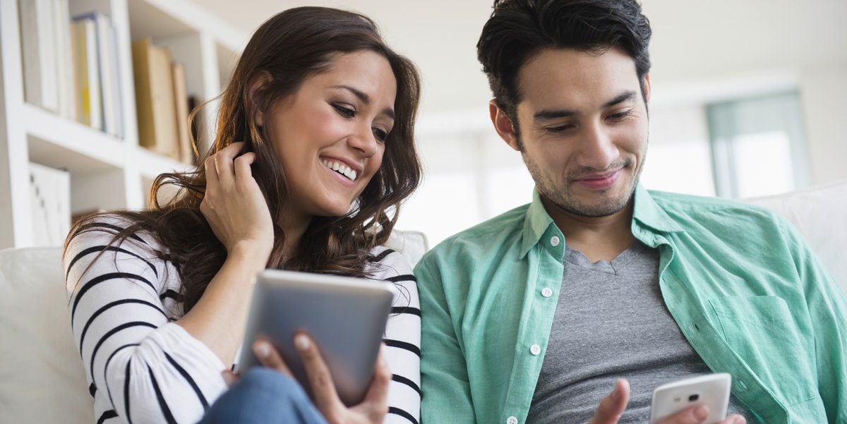 two coworkers looking at a tablet together