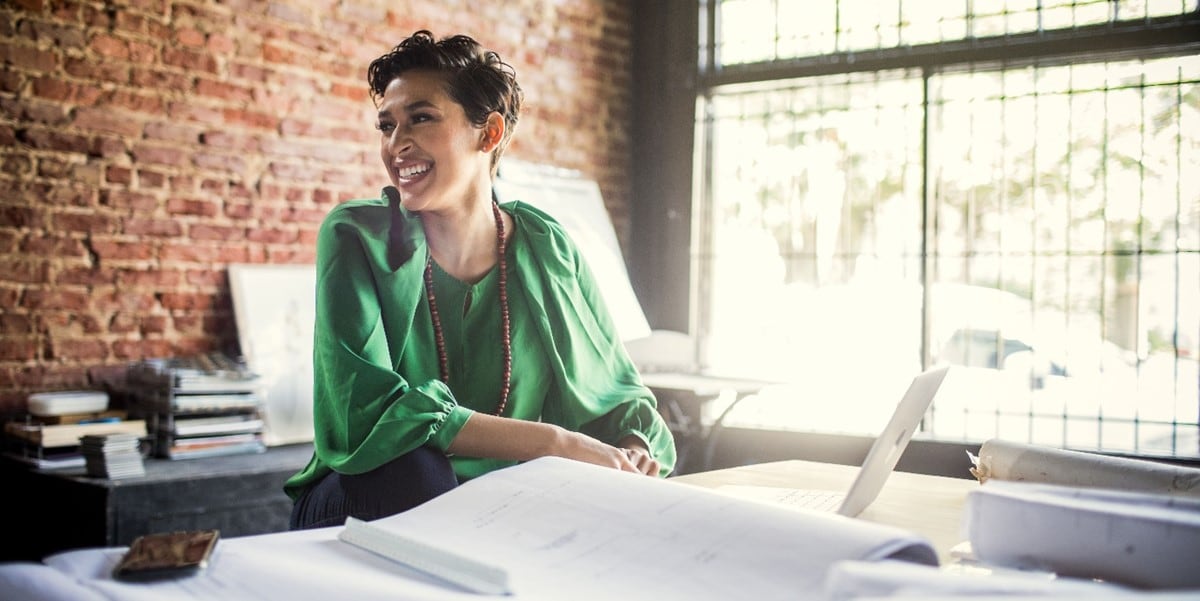 a businesswoman at her desk smiling