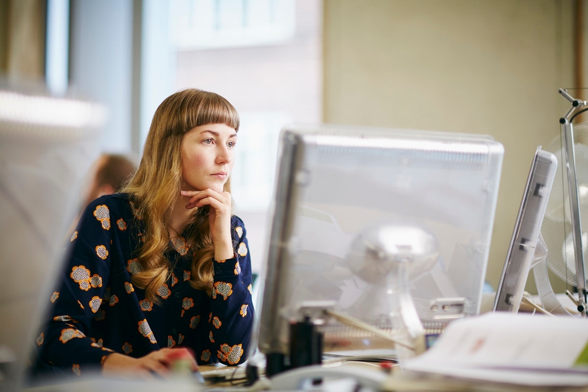 Lady with short fringe looking a computer screen