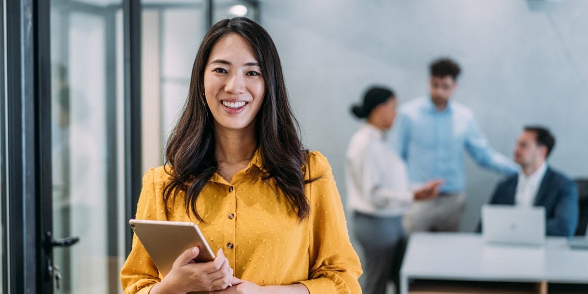 professional woman in office holding tablet