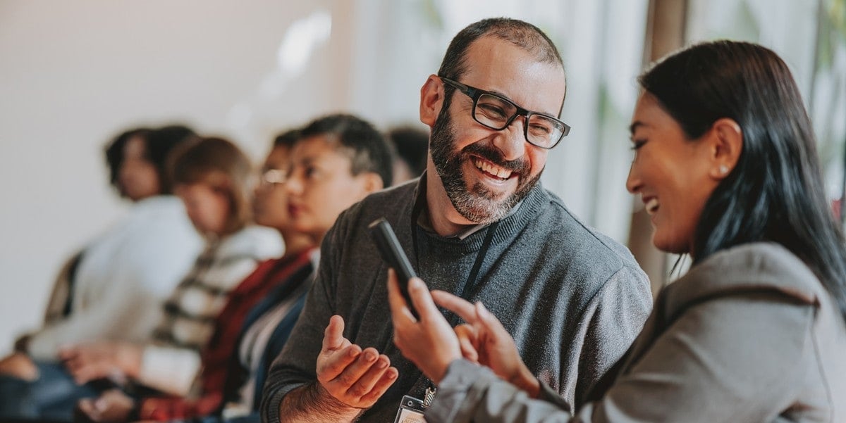 two professionals in office in discussion