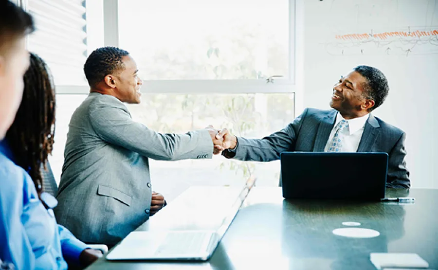 People shaking hands in a meeting